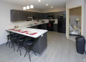 Thumbnail 29 of 32 - a view of the kitchen and living room in a bedroom plus den unit