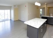 Thumbnail 25 of 32 - an open concept kitchen and living room in an apartment