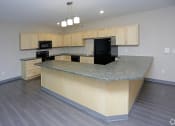 Thumbnail 24 of 32 - a kitchen with a large island with granite countertops