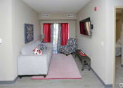 Thumbnail 23 of 32 - a living room filled with furniture and a flat screen tv