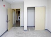 Thumbnail 22 of 32 - a laundry room with a washer and dryer and an open door