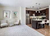 Thumbnail 1 of 36 - A modern kitchen with a dining table and chairs.
