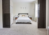 Thumbnail 5 of 36 - A bedroom with a large bed and a dresser.