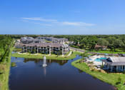 Thumbnail 36 of 43 - an aerial view of a community with a lake and a fountain