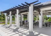 Thumbnail 33 of 43 - a patio with tables and chairs under a pavilion