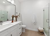 Thumbnail 43 of 43 - a white bathroom with a large mirror and a toilet