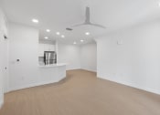 Thumbnail 21 of 43 - an empty living room with white walls and a ceiling fan