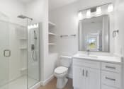 Thumbnail 11 of 43 - a white bathroom with a shower toilet and sink