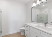 Thumbnail 17 of 43 - a bathroom with a sink and a toilet and a mirror