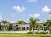 Thumbnail 39 of 43 - a large house with palm trees in front of it