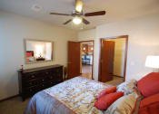 Thumbnail 17 of 21 - a bedroom with a large bed and a ceiling fan