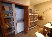 Thumbnail 15 of 21 - a bathroom with a washer and dryer in a closet
