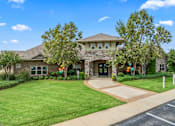 Thumbnail 3 of 34 - A house with a driveway and a green lawn. at The Villas at Nature Walk, Huntsville, 35824