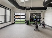 Thumbnail 47 of 52 - A room with a row of exercise bikes and a rack of weights at Ovation at Town Madison, Madison, AL