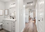 Thumbnail 38 of 52 - A bathroom with a white vanity and a mirror above it at Ovation at Town Madison, Madison, AL