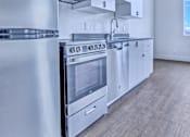 Thumbnail 3 of 18 - Kitchen with a Stove at Sloan's Place Apartments, Denver, CO