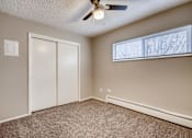 Thumbnail 6 of 12 - A room with a ceiling fan and a window with blinds.