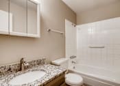 Thumbnail 8 of 12 - A bathroom with a sink, toilet, and bathtub.