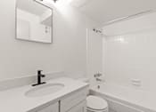 Thumbnail 3 of 19 - a bathroom with a sink and a tub and a toilet