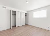 Thumbnail 2 of 19 - the living room of an apartment with white walls and wood flooring