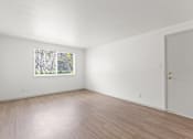 Thumbnail 6 of 19 - a room with white walls and wooden floors and a projection of different shapes and numbers