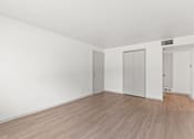Thumbnail 7 of 19 - an empty living room with white walls and wood floors