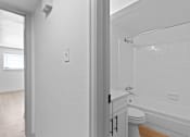 Thumbnail 16 of 19 - a bathroom with a toilet and a tub and a sink
