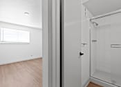Thumbnail 18 of 19 - an empty bedroom with a bathroom and a shower