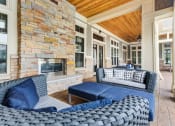 Thumbnail 2 of 15 - Apartments For Rent In Vernon Hills, IL - The Oaks of Vernon Hills - Outdoor Lounge Outside Resident Clubhouse With Plush Seating And Gas Fireplace