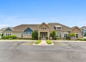 Thumbnail 14 of 15 - a large house with a parking lot in front of it
