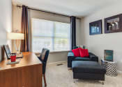 Thumbnail 17 of 20 - Aurora Apartments - The Apartments at Kirkland Crossing Office With Cozy Carpeting, Large Window, and Modern Decor