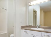 Thumbnail 10 of 30 - A bathroom with a white toilet and sink.