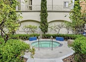 Thumbnail 4 of 30 - A small pool surrounded by bushes and trees.