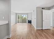 Thumbnail 13 of 30 - A room with wooden floors and white walls.