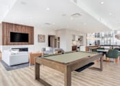 Thumbnail 8 of 19 - Community room pool table and a tv area