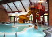 Thumbnail 31 of 31 - Mountain Park OR Apartments - MiLO at Mountain Park - Indoor Resort-Style Pool with Lap Swim Lanes, Recreational Swim Area, A Waterslide and a lot of Windows.