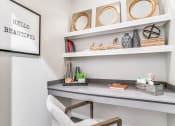Thumbnail 6 of 20 - Dallas TX Apartments-Office Area With Granite Built In Desk and White Wooden Shelves