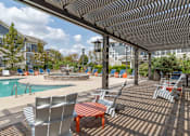 Thumbnail 8 of 14 - pergola covered seating area next to swimming pool
