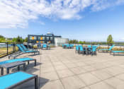 Thumbnail 14 of 18 - Apartments In Green, Lake Seattle, WA, for Rent - Circa Green Lake - BBQ Area With Lounge Seats, Tables And Chairs, And Expansive Views.