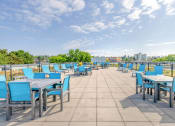 Thumbnail 15 of 18 - the terrace of the building with tables and chairs and a view of the city