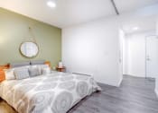 Thumbnail 10 of 18 - a bedroom with a bed and a mirror