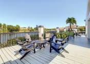 Thumbnail 4 of 33 - Apartments In Coconut Creek for Rent – Waterview at Coconut Creek – sun deck overviewing lake with seating area