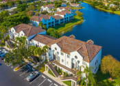 Thumbnail 28 of 33 - Coconut Creek Apartments – Waterview at Coconut Creek – aerial view of community building and lake