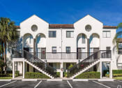 Thumbnail 29 of 33 - Pet-Friendly Apartments in Coconut Creek, FL – Waterview at Coconut Creek – community building with stairs and parking spots in front
