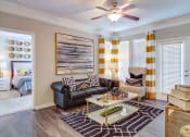 Thumbnail 8 of 25 - Pet-Friendly Apartments in Alpharetta, GA – The Ascent at Windward – living room with lots of space, hardwood floors, ceiling fans and large windows