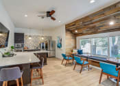 Thumbnail 19 of 31 - a kitchen and living room with a large window and a ceiling fan