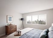Thumbnail 9 of 31 - Mountain Park Apartments - MiLO at Mountain Park - Spacious Bedroom with Large Window, a Bed, Double Nightstands, and Carpet.