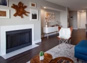 Thumbnail 4 of 31 - Apartments for Rent in Mountain Park - MiLO at Mountain Park - Living Room with Wood-Style Flooring, Area Rug, Coffee Table, Chair, and Fireplace