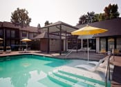 Thumbnail 2 of 27 - Apartments for Rent - Wilsonville, Oregon - Resort Style Pool with Lounge Chairs and Shaded Areas