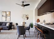 Thumbnail 1 of 27 - Pet-Friendly Apartments - Bridge Creek Apartments - Living Room with Ceiling Fan and Modern Dining Area